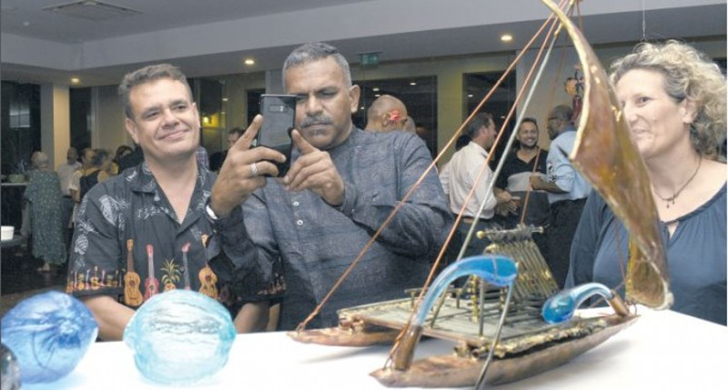 Shane Bower (left) and Alice Hill (right) watch as the Minister for Industry, Trade, Tourism, Lands and Mineral Resources Faiyaz Koya takes pictures of the artwork during the Three Dimension Art Exhibition at the Grand Pacific Hotel on October 18, 2017. Photo: Vilimoni Vaganalau.